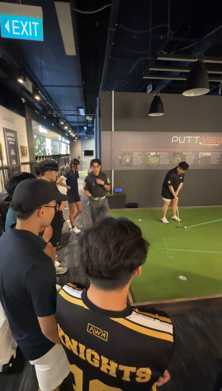 Guests receiving hands-on putting instruction